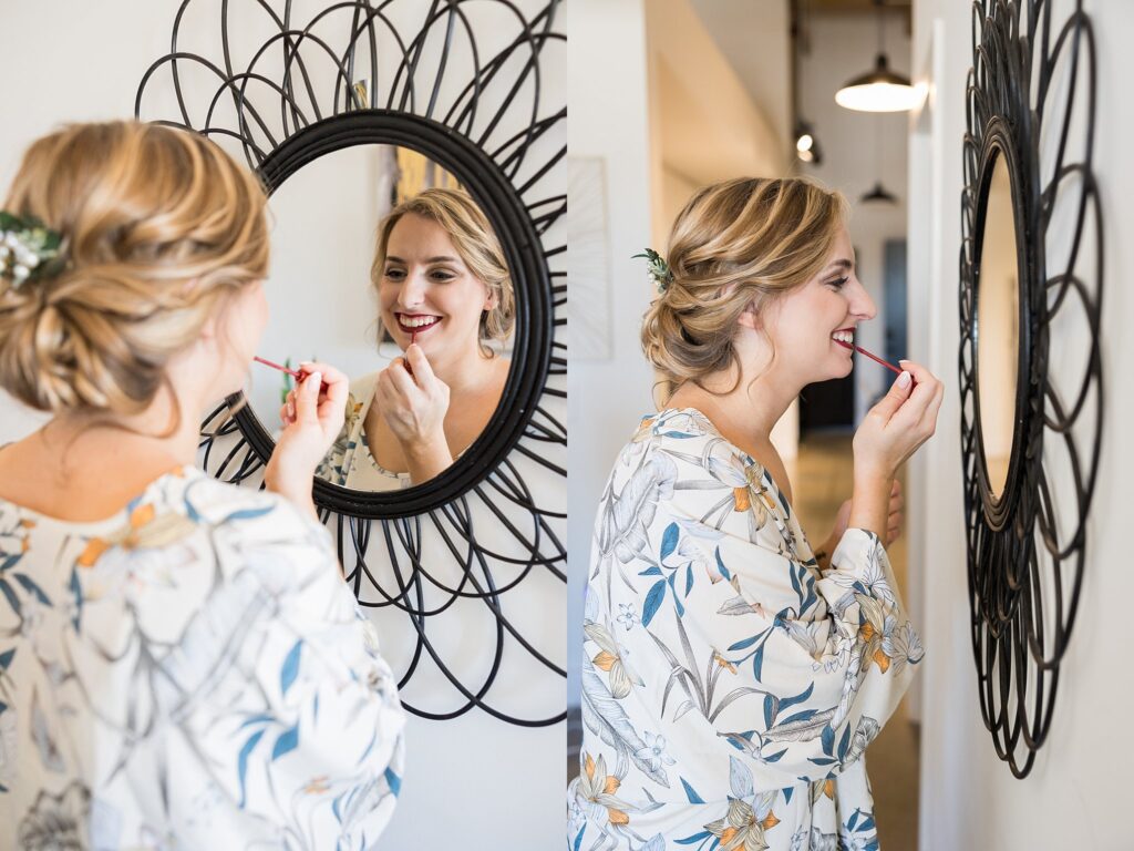 The bride sits elegantly in front of a mirror, having her makeup delicately applied for her special day at Judson Mill, downtown Greenville, South Carolina