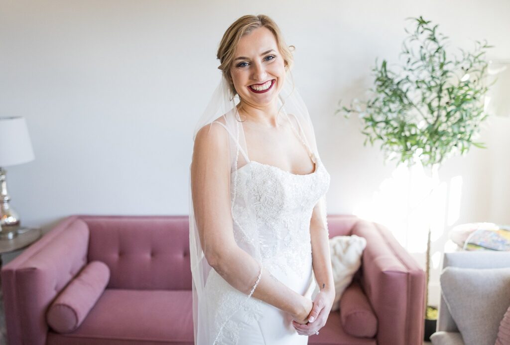 The bride's stunning bridal portrait showcases her radiant beauty and the picturesque backdrop of Judson Mill in downtown Greenville, South Carolina.