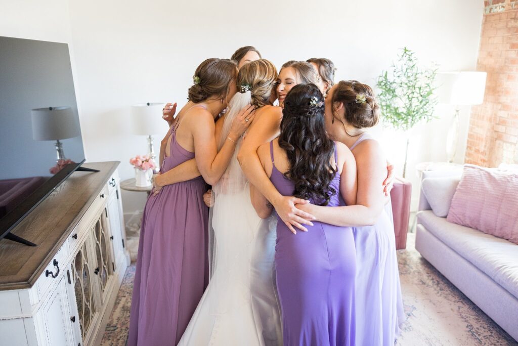A beautiful display of emotion as the bridesmaids eagerly gather to witness the bride's first look at Judson Mill, downtown Greenville, South Carolina.