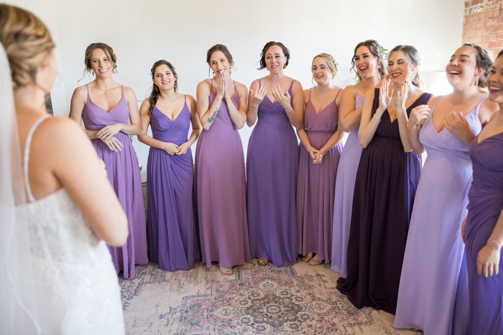 A heartwarming moment as the bridesmaids eagerly await the bride's arrival for their first look at Judson Mill, downtown Greenville, South Carolina.