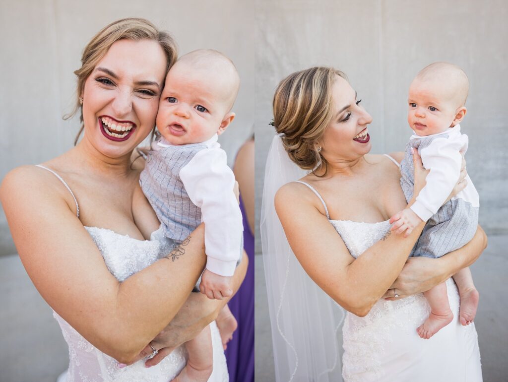 The bride's radiant smile matches the adorable baby she tenderly holds, creating a heartwarming moment at Judson Mill wedding.