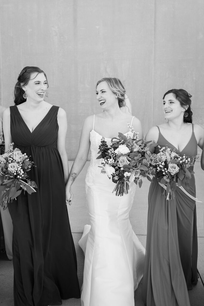 The bride and her lovely bridesmaids sharing a joyful moment during their special day at Judson Mill.