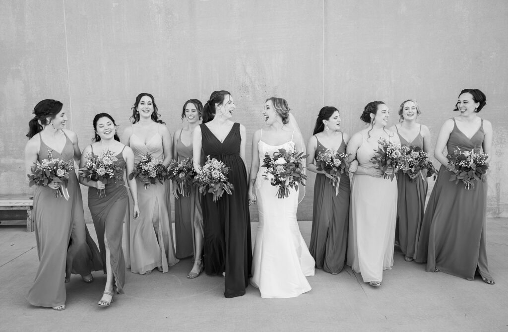 Beautiful bride surrounded by her radiant bridesmaids at Judson Mill wedding in downtown Greenville, South Carolina.