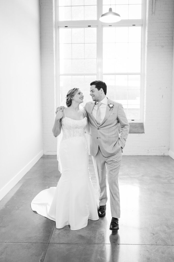 In this breathtaking wedding portrait, the couple's love and joy are palpable, as they radiate happiness against the dreamy backdrop of Judson Mill, creating a beautiful, bright, and airy scene.