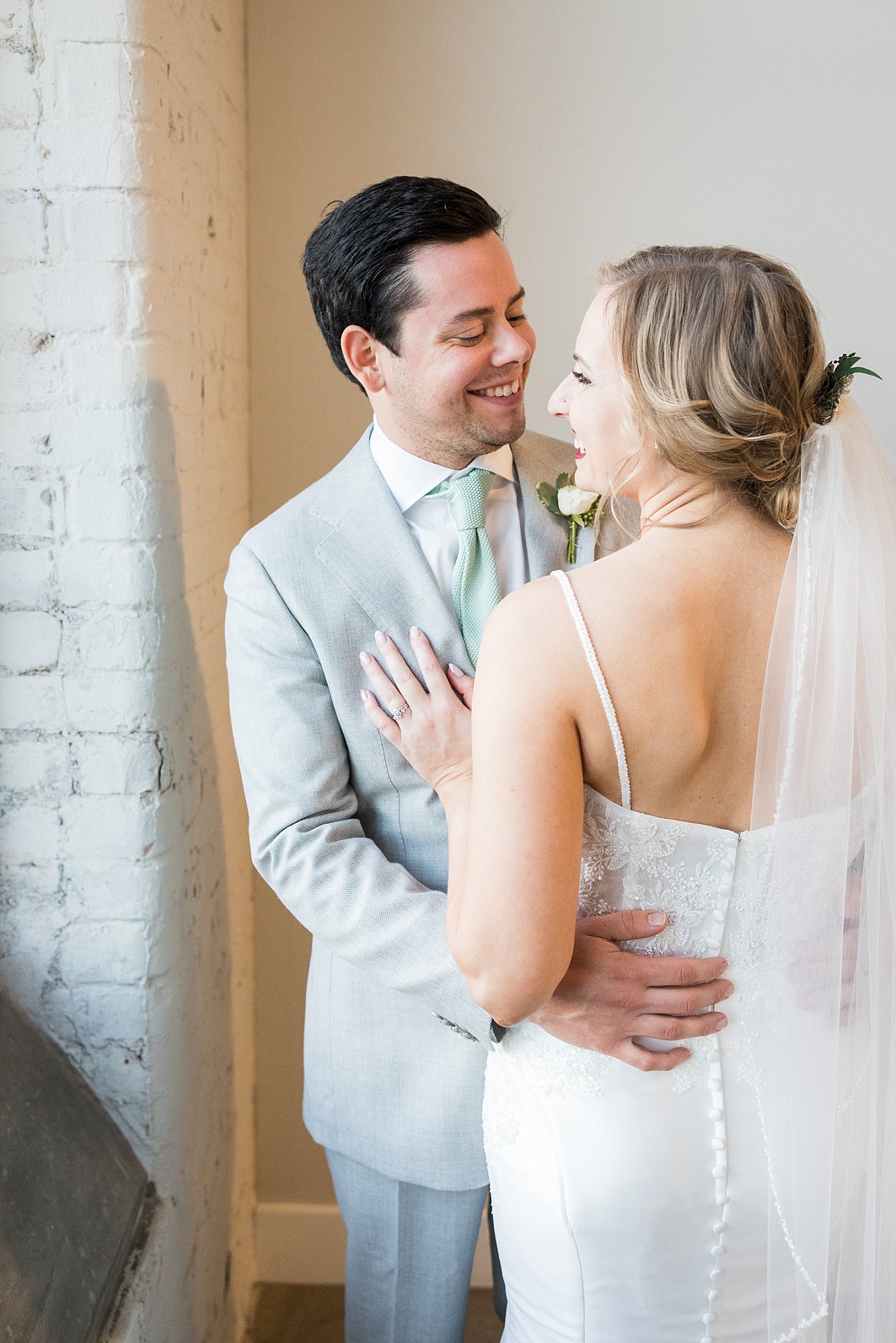 A heartwarming wedding portrait showcasing the couple's pure joy and love, surrounded by the enchanting atmosphere of Judson Mill in downtown Greenville, South Carolina.