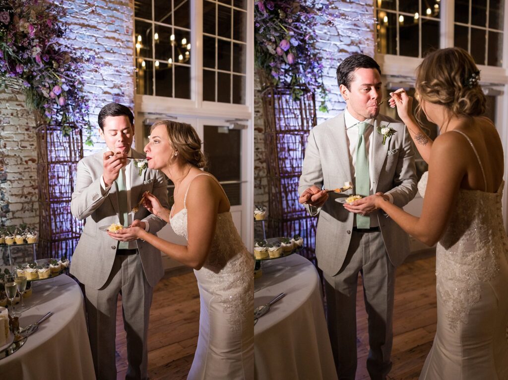 A heartwarming moment as the bride and groom, surrounded by loved ones, share their first slice of cake at their Judson Mill wedding in downtown Greenville.