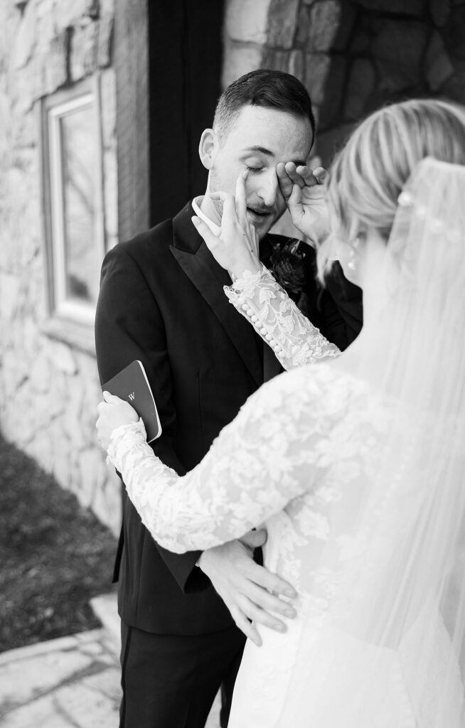 Lace + Honey's photograph capturing the groom's heartfelt reaction, as tears stream down his face during the first look with his bride.