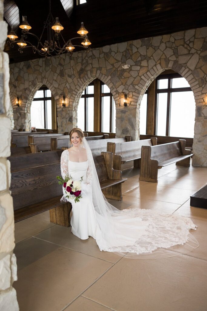 Image of the beautiful bride reading her letter inside Glassy Chapel by Lace + Honey.
