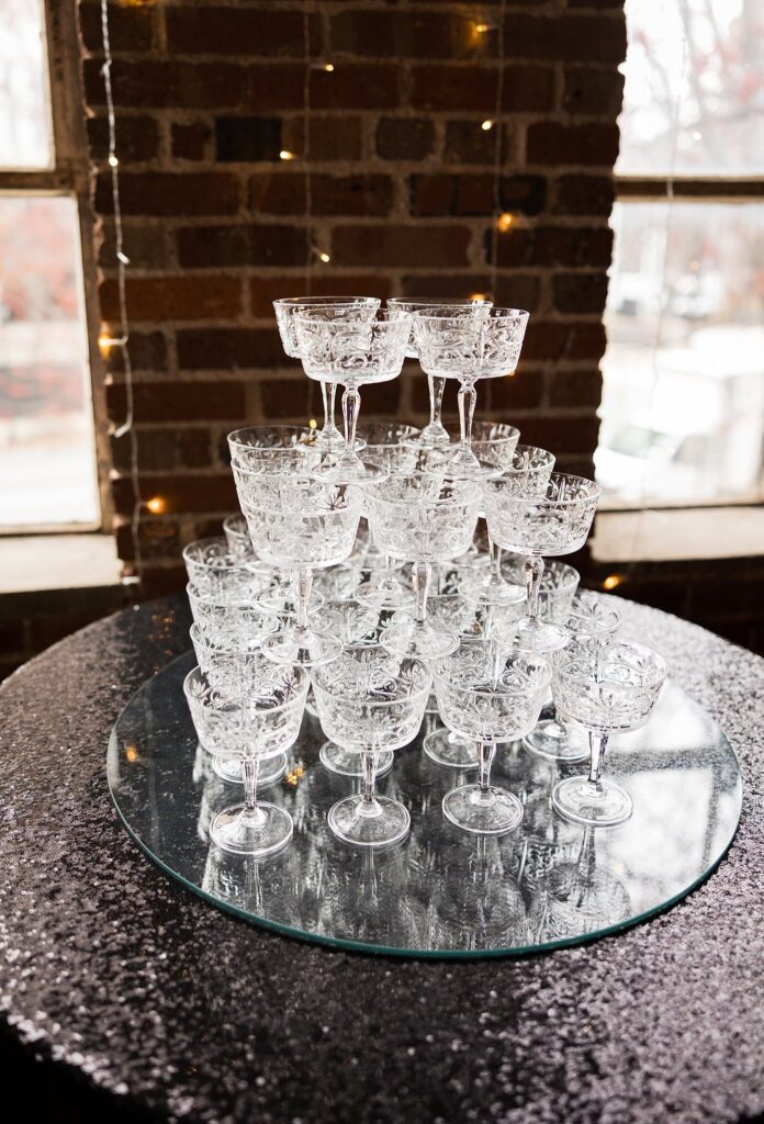 Champagne tower at the wedding reception, expertly captured by Lace + Honey.