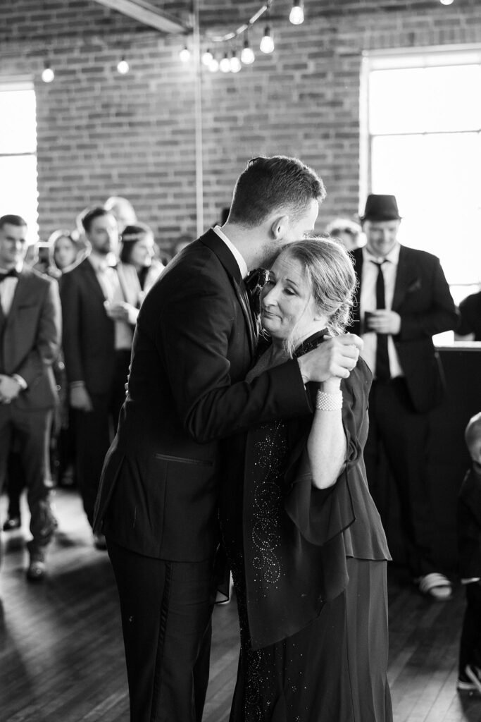 Image of the groom and his mother's sweet dance, shot by Lace + Honey.