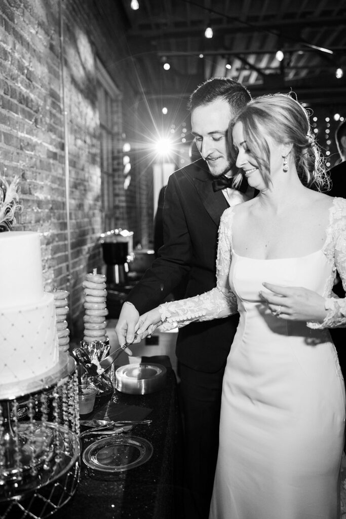 Image of the couple's sweet cake cutting moment by Lace + Honey.