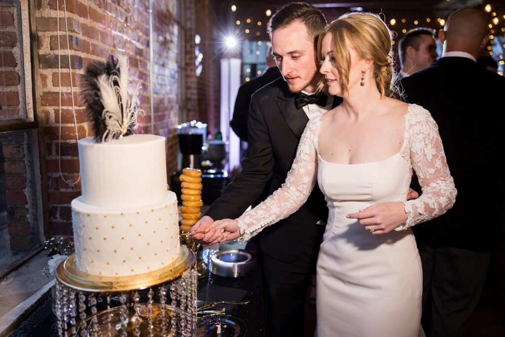 Wedding cake cutting ceremony at the reception, photographed by Lace + Honey