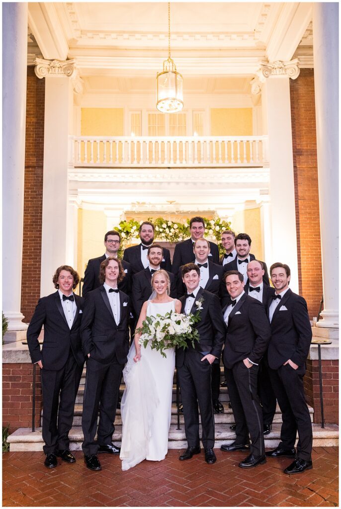 Groomsmen in black tuxes from The Black Tux with bride