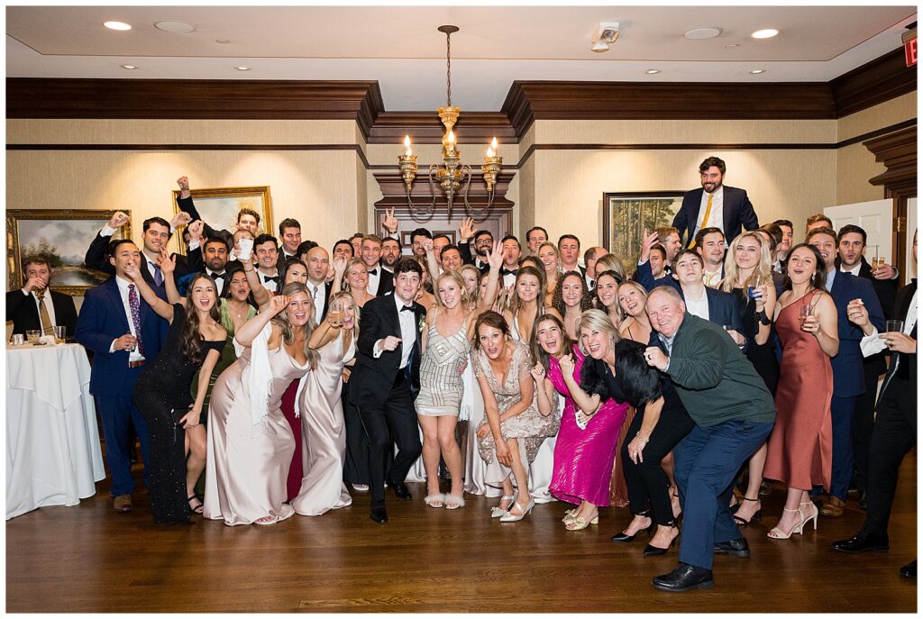 large picture of all friends at wedding reception