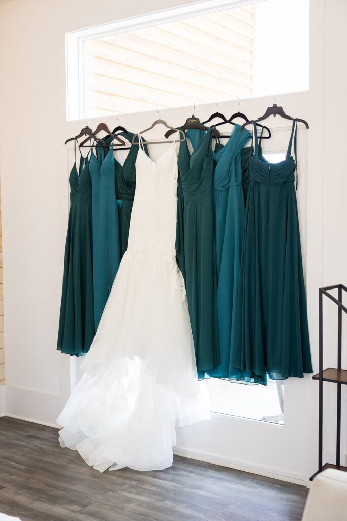 Chic bridesmaid dresses hanging at South Wind Ranch, Travelers Rest SC - The bridesmaids' dresses hang in unity, adding a touch of style and elegance to the upcoming celebration