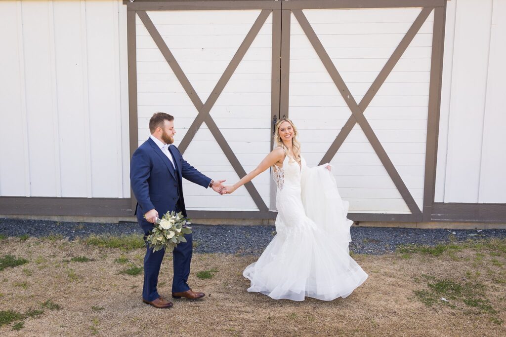 Happily Ever After Begins: Bride and Groom in Front of the Reception Barn at South Wind Ranch - A beautiful start to their new chapter.