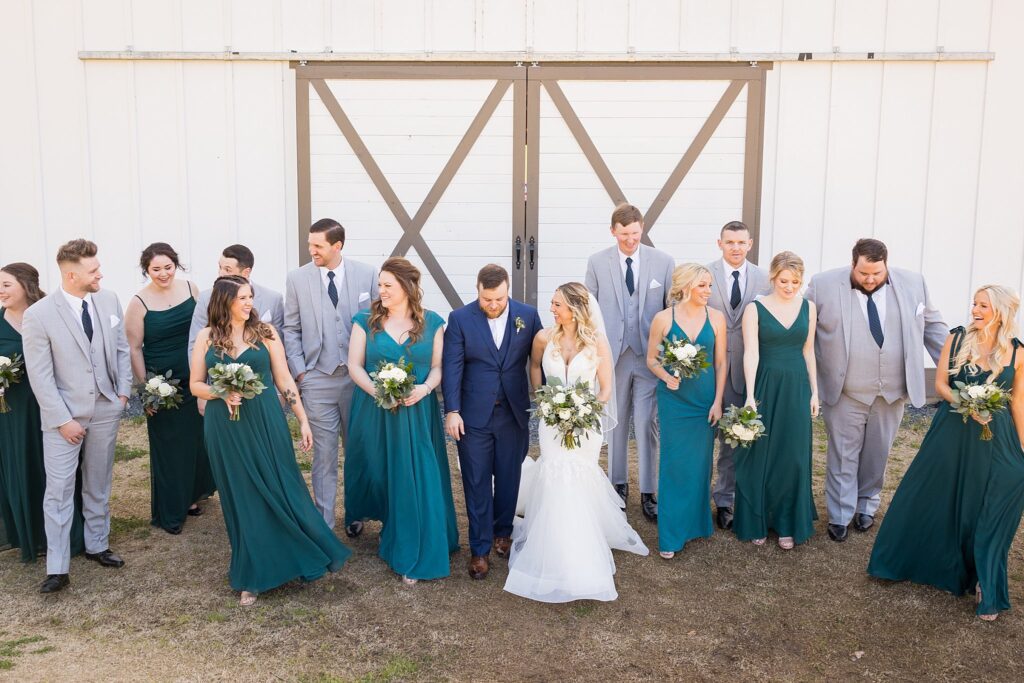 Joyful Gathering: Bridal Party with Bridesmaids and Groomsmen at South Wind Ranch - The entire group sharing in the couple's happiness.