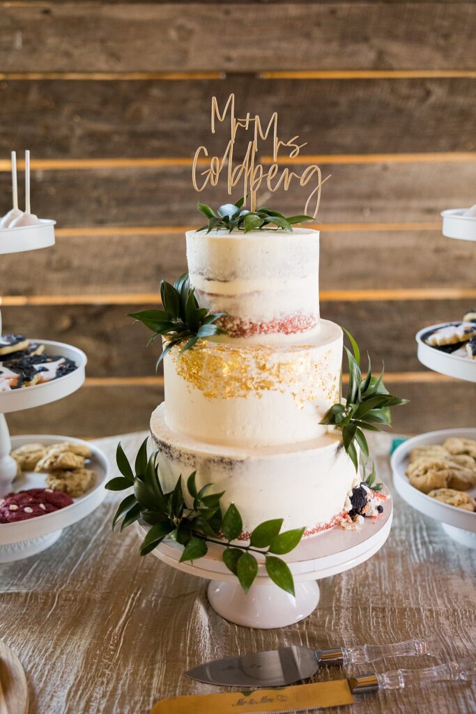Cake Table Elegance: A Stunning Display at South Wind Ranch - Showcasing the beautifully adorned wedding cake and delightful dessert spread
