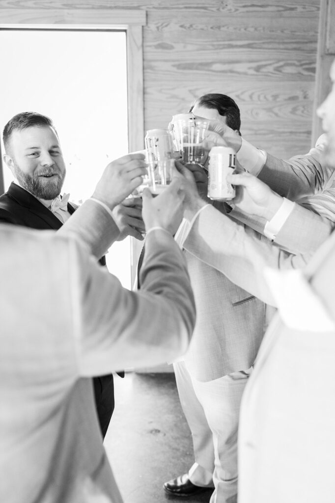 Pre-Reception Cheers: Groomsmen Enjoying Shots at South Wind Ranch - Sharing lighthearted moments and toasting to the couple's happiness