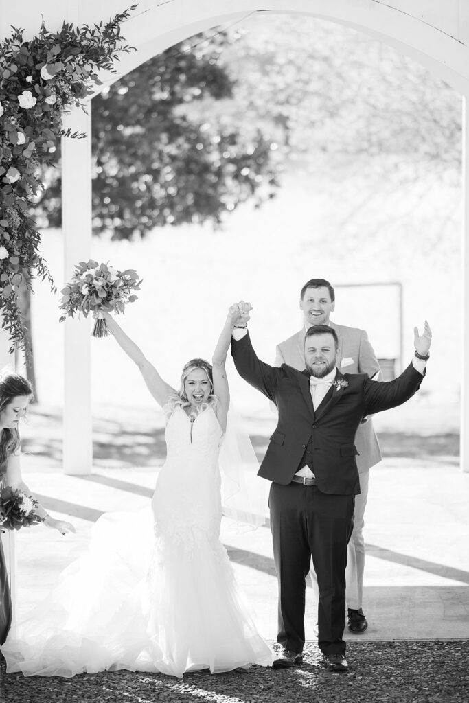 Pure Euphoria: Bride and Groom Celebrating Their Union at the Ceremony - Radiating pure joy and excitement as they begin their married life together