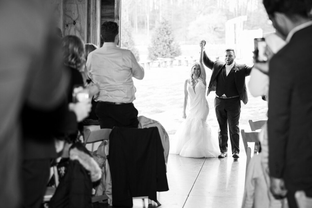 Grand Entrance: Bride and Groom's Reception Introduction at South Wind Ranch Wedding - Embarking on their celebration with joy and excitement