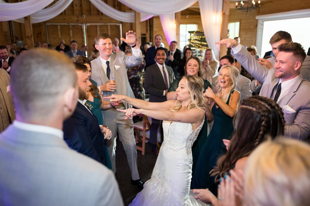 Joyful Celebration: Bride and Groom Engaging with Guests on the Dance Floor - Creating cherished memories with family and friends.