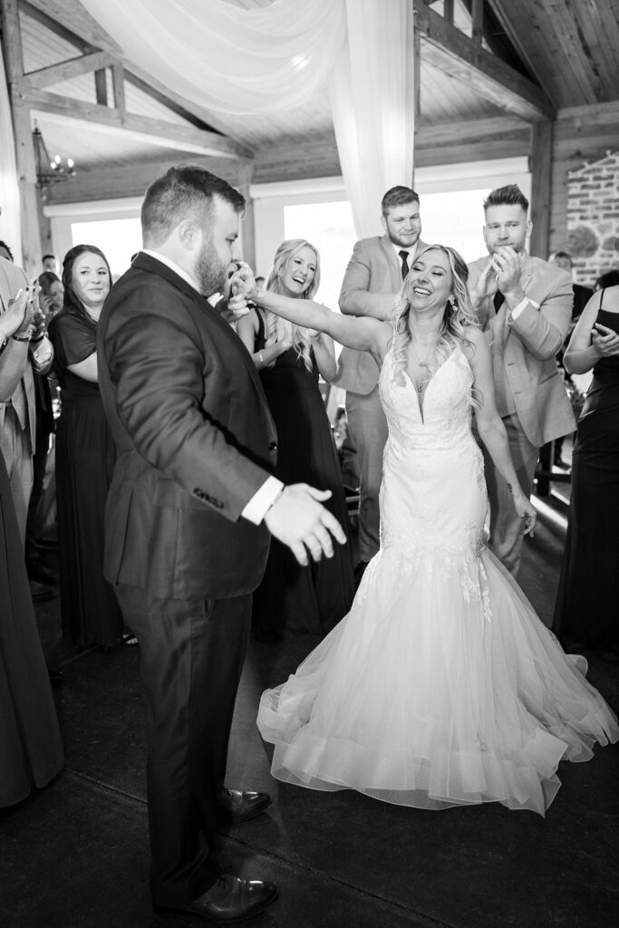 Dancing in Harmony: Bride and Groom with Guests on the Dance Floor - The dance floor radiating with unity and happiness.