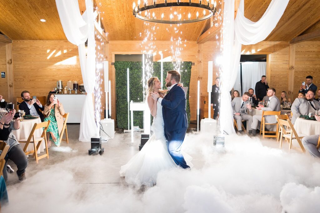Capturing the Magic: Bride and Groom's First Dance with Fog and Sparkler Machines - A mesmerizing display of love and enchantment.
