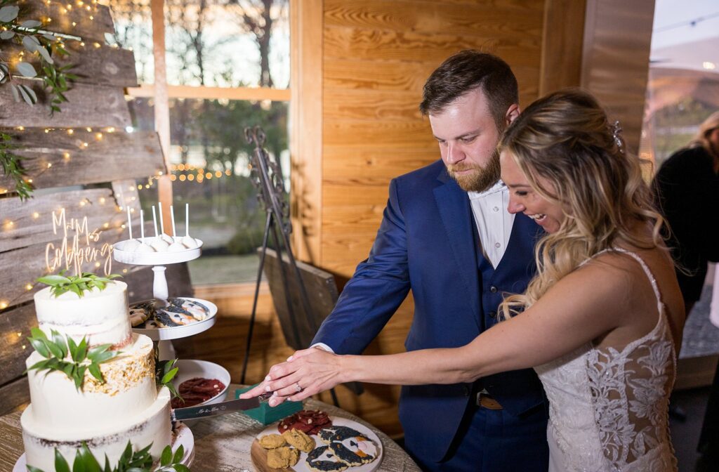 Sweet Beginnings: Bride and Groom Sharing a Playful Moment while Cutting the Cake - A delightful start to their journey as they cut their wedding cake together