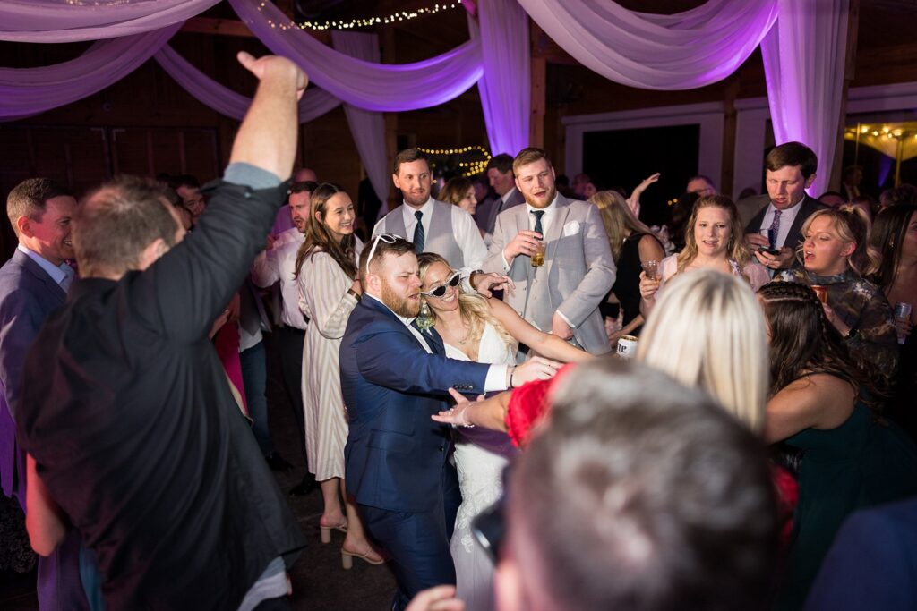 Rhythms of Love: Guests, Bride, and Groom Dancing the Night Away at South Wind Ranch - A Celebration of Love.