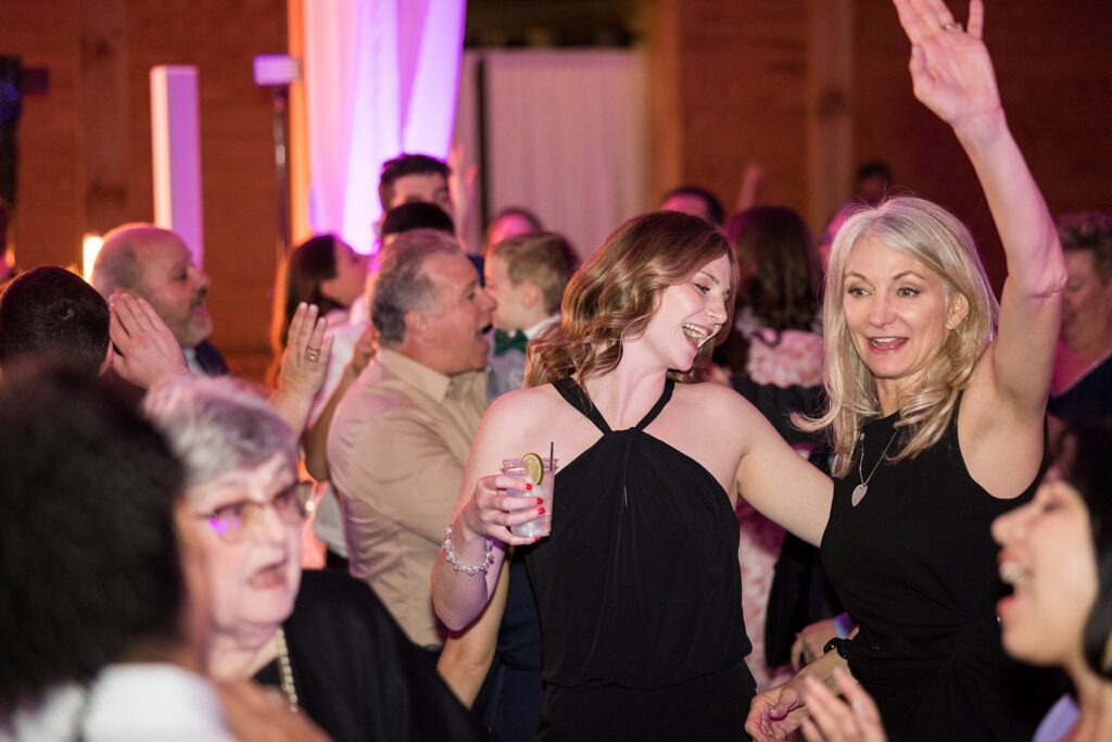Dancing the Night Away: Guests Celebrating on the Dance Floor at South Wind Ranch - A lively reception filled with laughter and dance.